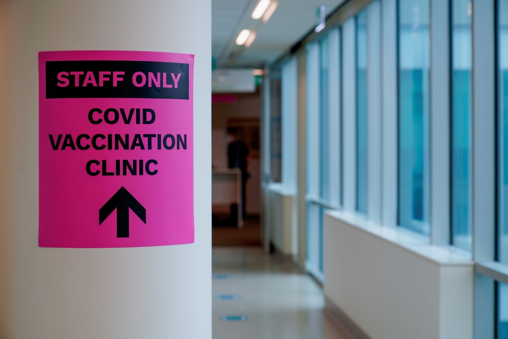FILE PHOTO: A sign for a COVID-19 vaccination clinic is seen in Melbourne