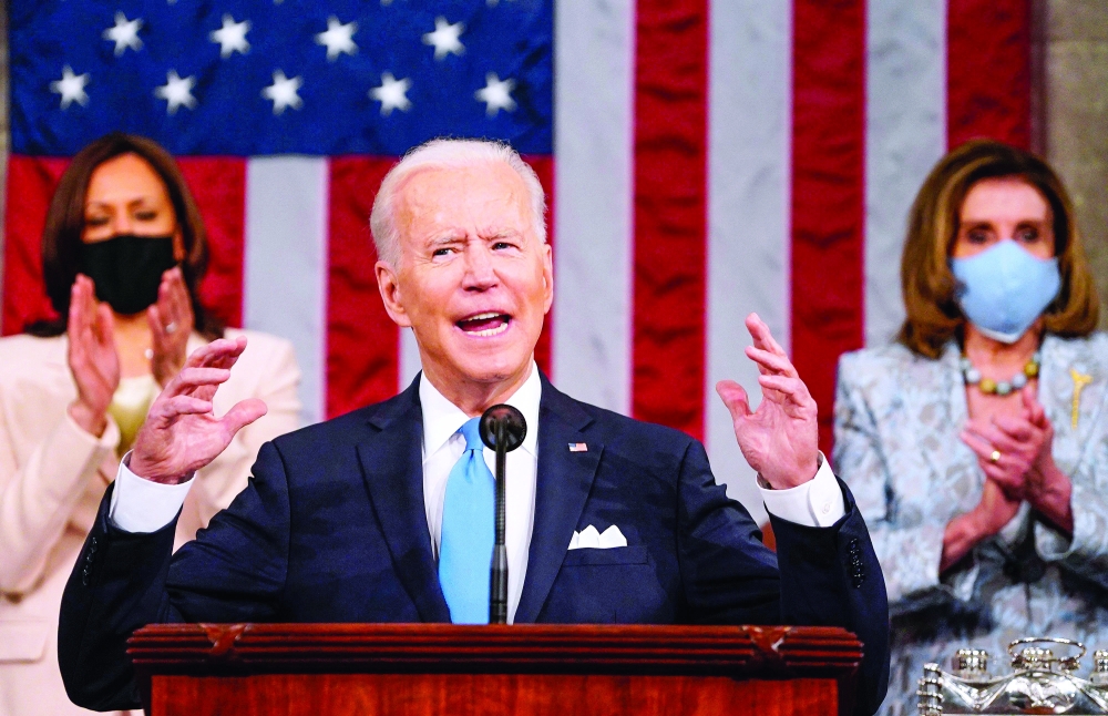 US President Joe Biden addresses a joint session of Congress as US Vice President Kamala Harris and US Speaker of the House Nancy Pelosi applaud at the US Capitol in Washington, DC. - AFP 