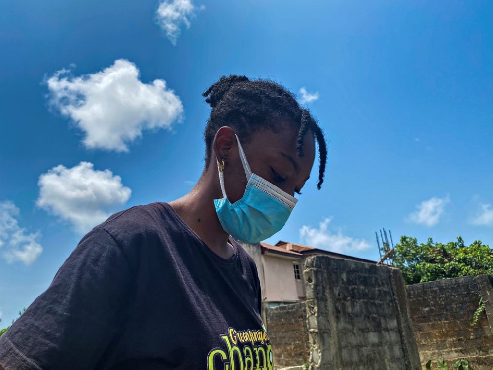 Esohe Ozigbo, a 15-year-old climate change activist, is seen during one of her campaign picking up refuse disposed carelessly in Lagos, Nigeria 