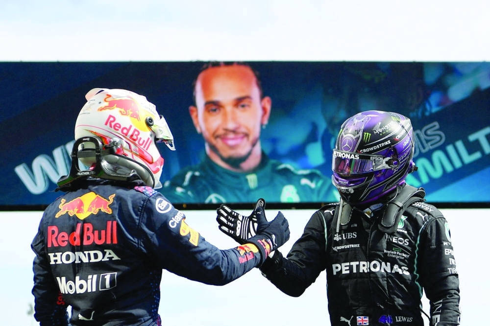 Red Bull's Max Verstappen (L) congratulates Mercedes' Lewis Hamilton after he won the Portuguese F1 Grand Prix. -- AFP