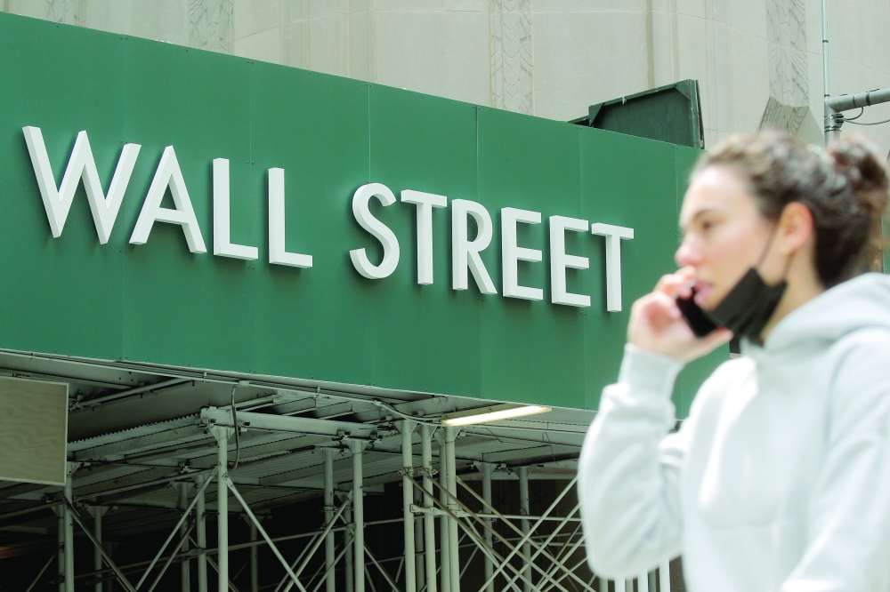 A Wall Street sign is seen near the New York Stock Exchange (NYSE) in New York City. - Reuters