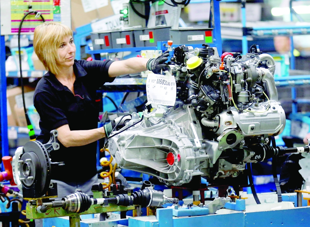 A Nissan Motor staff works on an engine in the assembly line at the Zona Franca Nissan factory near Barcelona. - Reuters File Photo
