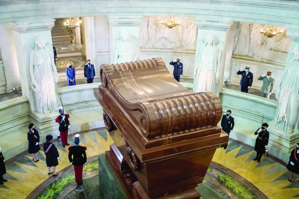 French President Emmanuel Macron and his wife Brigitte Macron stand in front of Napoleon's tomb during a ceremony to commemorate the 200th anniversary of Napoleon Bonaparte's death, at the Hotel des Invalides in Paris, on Wednesday. - Reuters