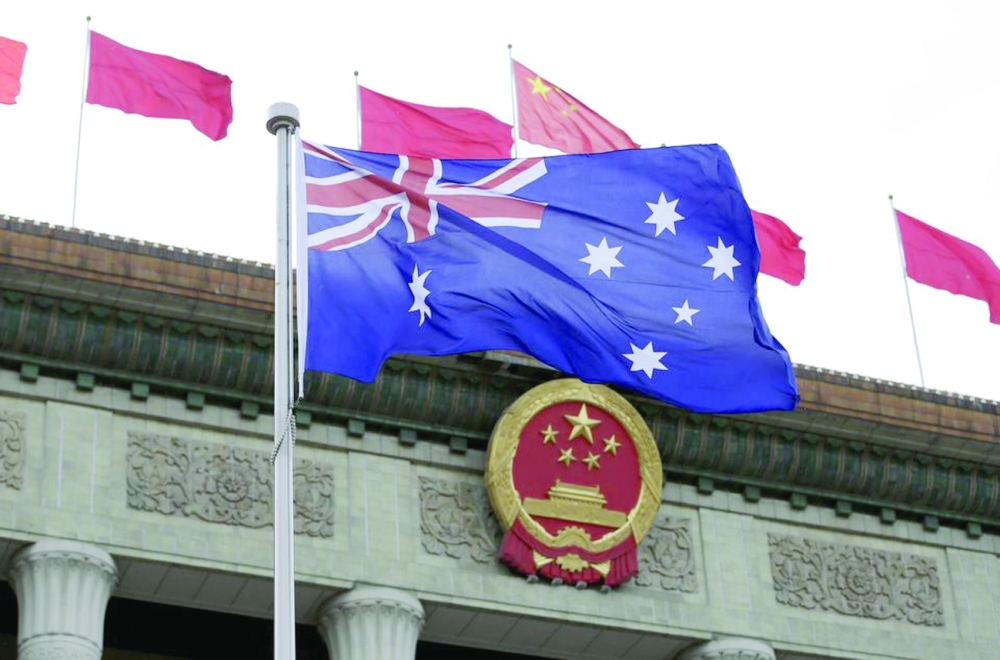Australian flag flutters in front of the Great Hall of the People during a welcoming ceremony for Australian Prime Minister Malcolm Turnbull (not in picture) in Beijing. - Reuters File Photo