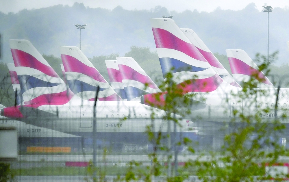 Aircraft grounded due to the Covid-19 pandemic, including planes operated by British Airways, stand on the apron at London Gatwick Airport near Crawley, southern England. - AFP 