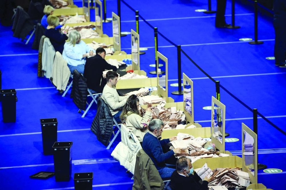 Staff count ballot papers for the Scottish parliament elections at the count centre at the Emirates Arena in Glasgow. - AFP