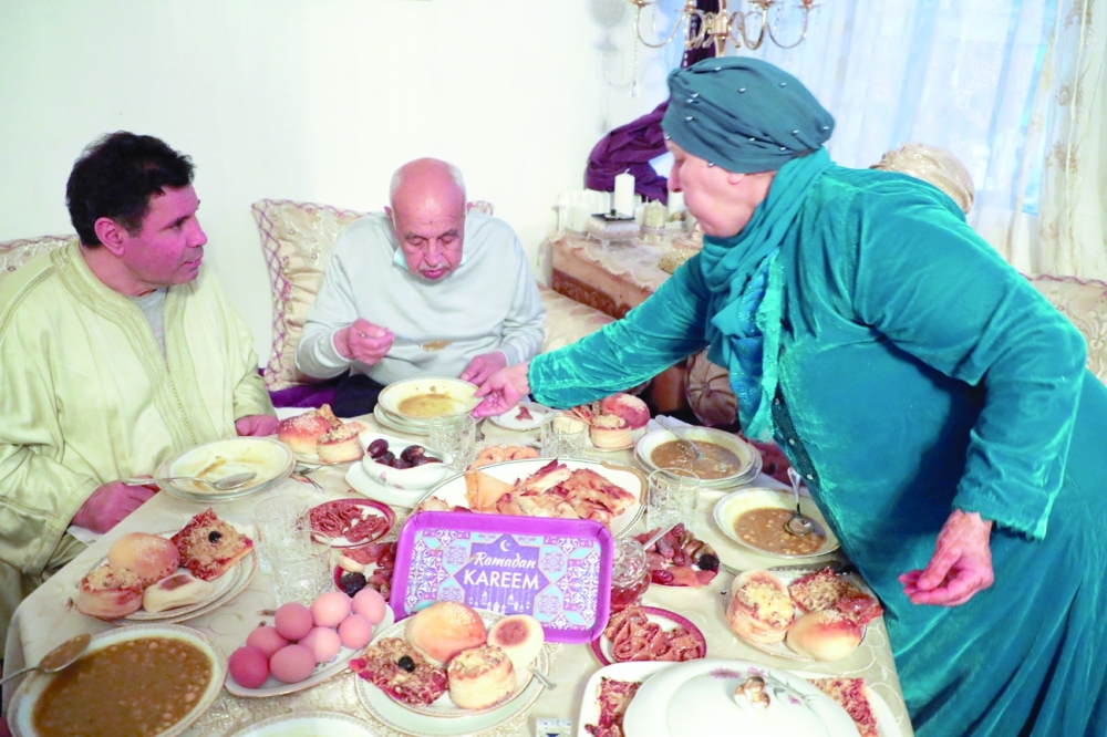 Family including Aziz El Moujahid, his wife Lalla Aicha El Moujahid and two friends of the family break fast at Ramadhan during the nationwide curfew from 7 pm to 6 am, and under restrictions limiting gatherings at houses up to 6 people due to tighter measures against the spread of coronavirus disease in Aulnay-sous-Bois near Paris. - Reuters 