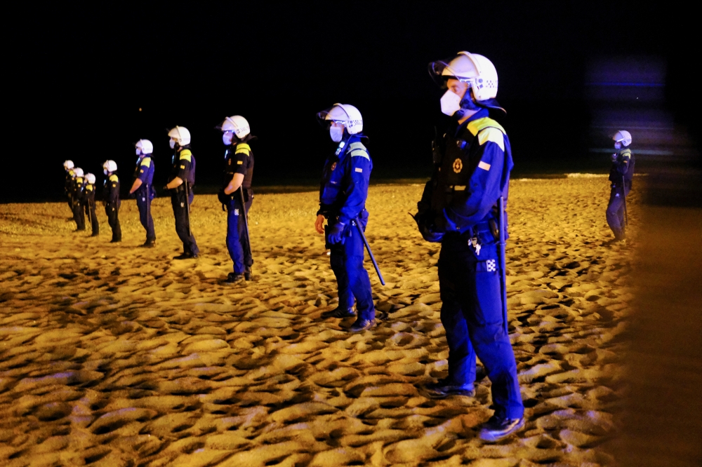 Police officers patrol the beach of Barceloneta, as the state of alarm decreed by the Spanish Government to prevent the spread of the coronavirus disease ends in Barcelona. - Reuters