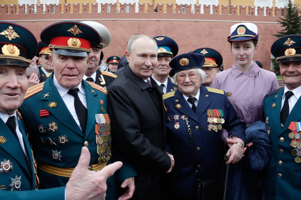 Russian President Vladimir Putin meets with veterans after the Victory Day military parade in Moscow. - AFP 