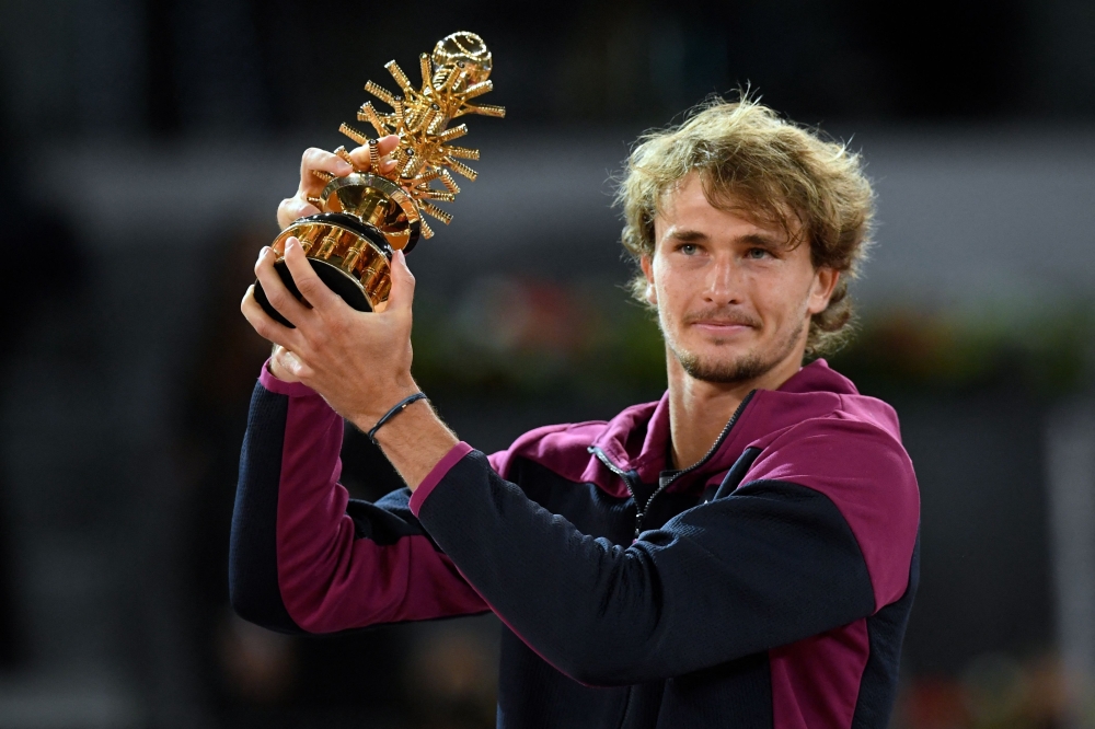 Germany's Alexander Zverev holds up the winner's trophy after beating Italy's Matteo Berrettini in Madrid. -- AFP