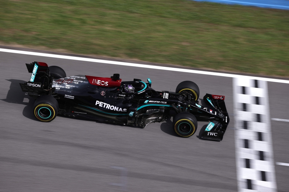 Mercedes' Lewis Hamilton crosses the finish line at the Spanish GP race at the Circuit de Catalunya. -- AFP