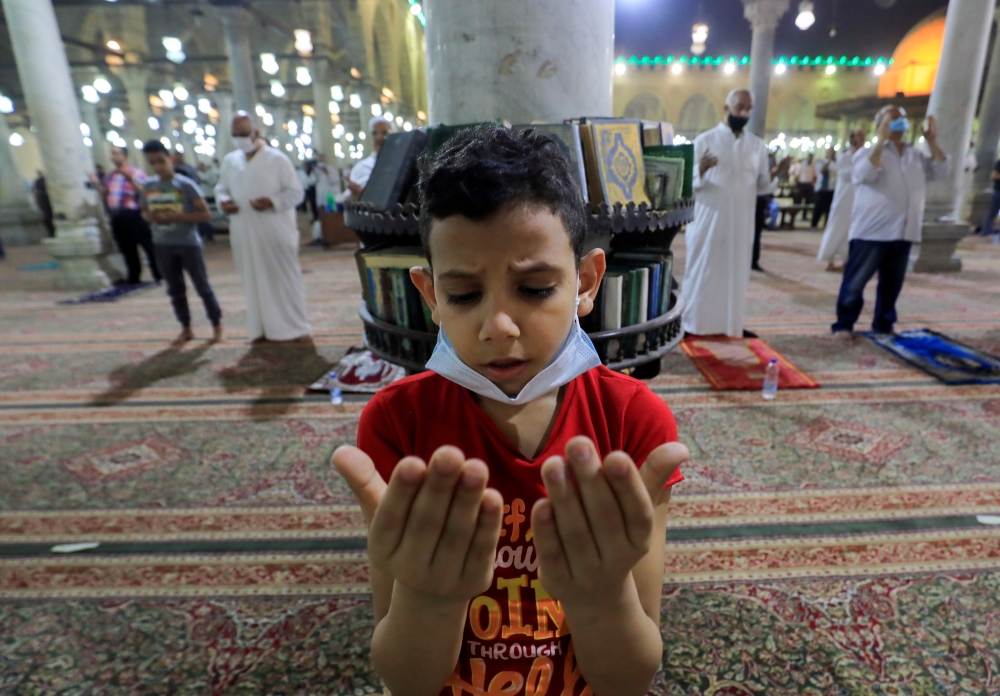 A boy takes part in evening prayers called 'Taraweeh' on Laylat-ul-Qadr or Night of Decree. -- Reuters

