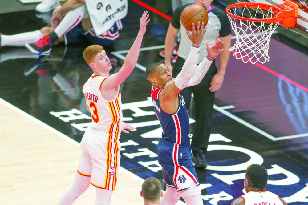 Washington Wizards' Russell Westbrook (4) shoots past Atlanta Hawks' Kevin Huerter (3) at State Farm Arena. -- USA Today Sports