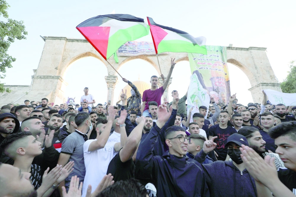Palestinians attend Eid al Fitr prayers at the compound that houses Al Aqsa mosque in Gaza. - AFP
