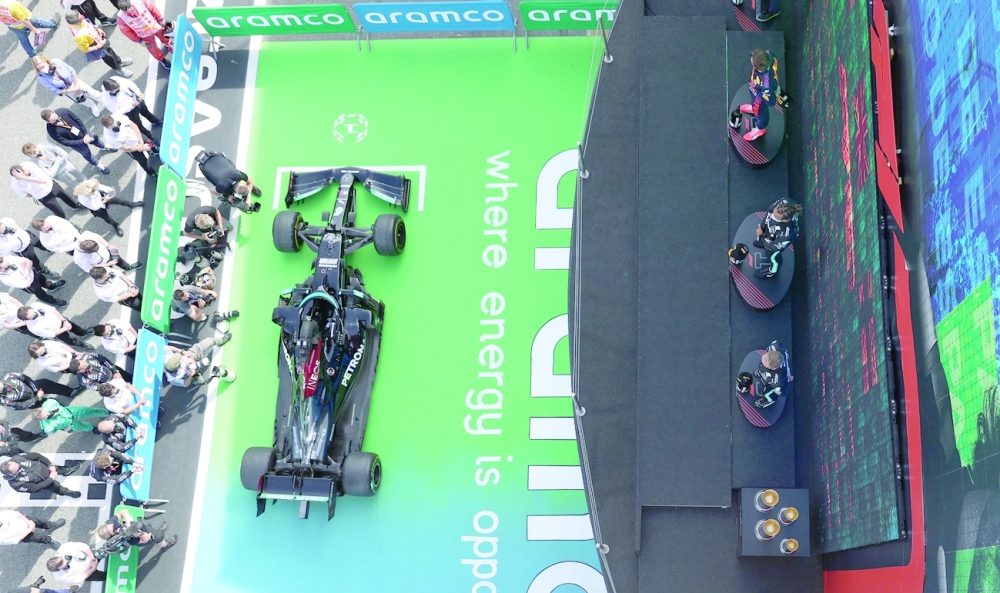 Mercedes' Lewis Hamilton standing on the podium after winning the race alongside second placed Red Bull's Max Verstappen and third placed Mercedes' Valtteri Bottas. -- Reuters