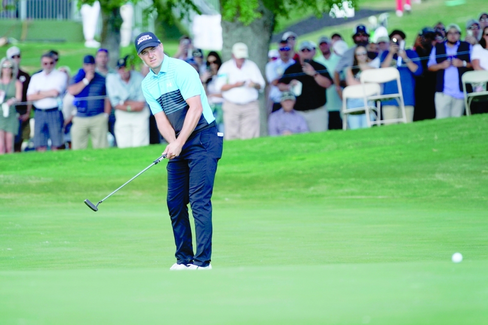 Jordan Spieth watches his putt on the 18th green for an eagle during the first round of the AT&T Byron Nelson tournament. -- USA Today Sports