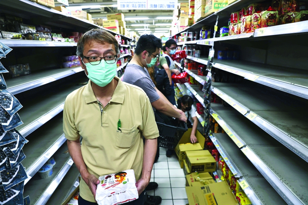 Customers rush to shop after the government advised people to reduce leaving their homes and limit gatherings due to an increasing number of locally transmitted infections in Taipei. - Reuters
