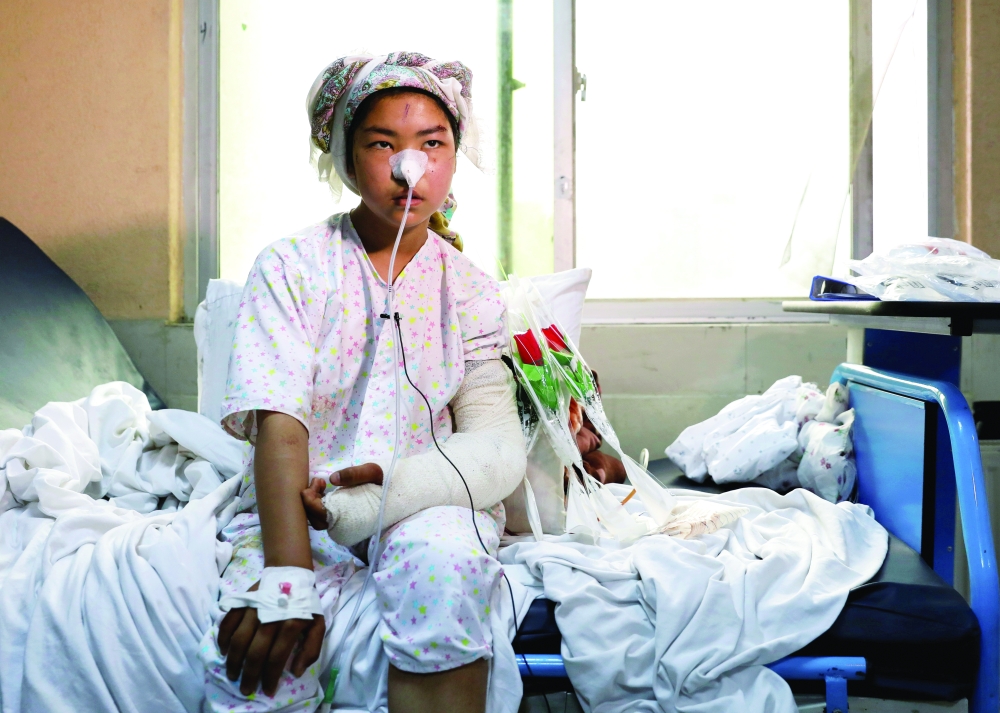 Ruqia Bakhshi, one of the students who was injured in a car bomb blast outside a school receives treatment at a hospital in Kabul. - Reuters 