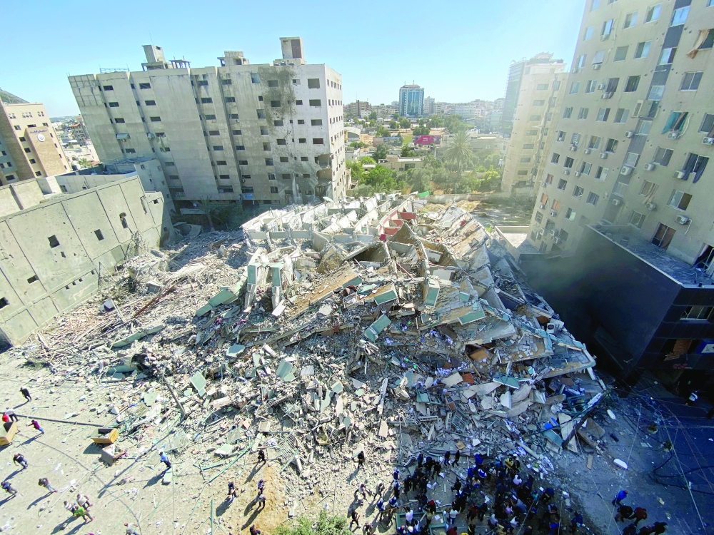 A tower housing AP, Al Jazeera offices collapses after Israeli missile strikes in Gaza city. - Reuters