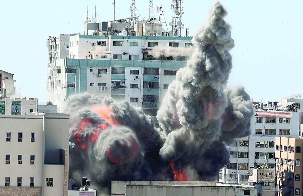 A ball of fire erupts from the Jala Tower as it is destroyed in an Israeli airstrike in Gaza city on Saturday. - AFP
