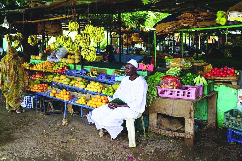 A Sudanese vendor waits for customers at a bazaar in Khartoum. — Reuters