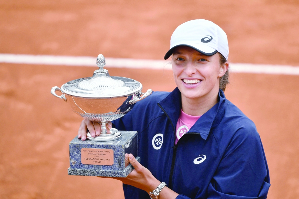 Poland's Iga Swiatek with the trophy after beating Czech Republic's Karolina Pliskova in the final of Italian Open. -- AFP