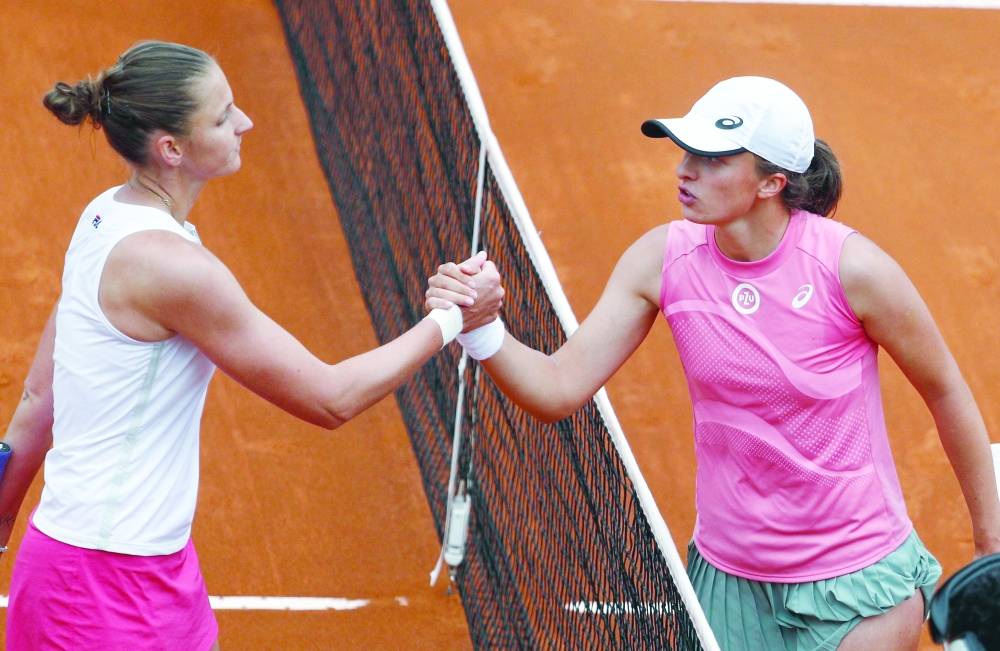Poland's Iga Swiatek shakes hands with Czech Republic’s Karolina Pliskova after winning the final. -- Reuters