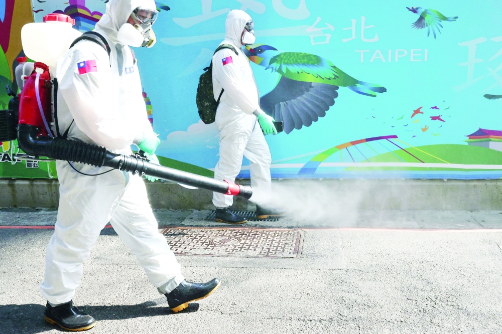 Soldiers disinfect Wanhua district, an area that has one of the most cases of coronavirus disease in the city in Taipei. - Reuters