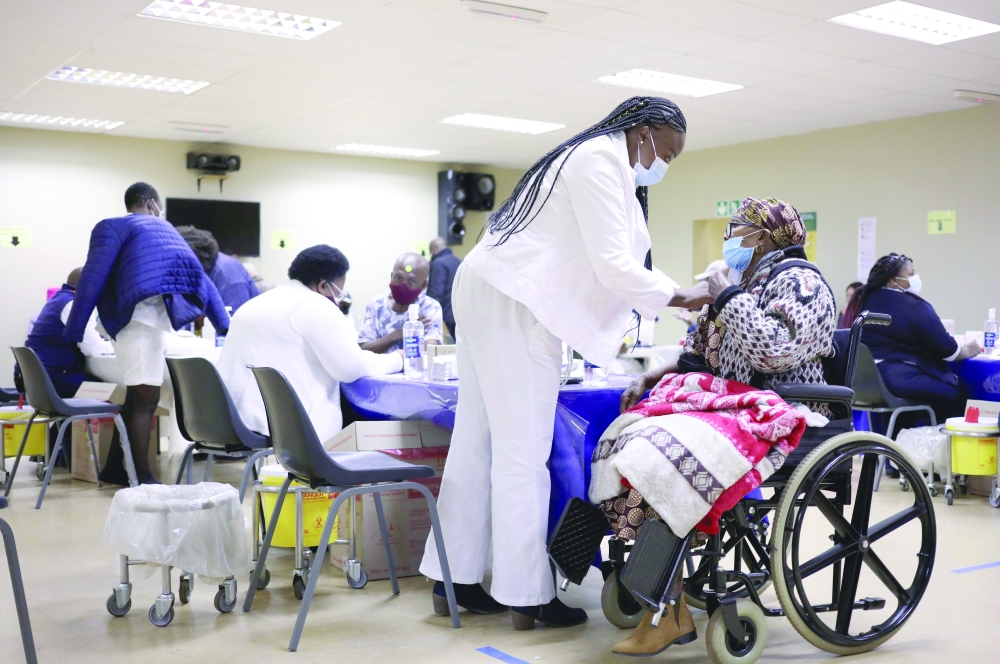 A woman receives a dose of a coronavirus disease vaccine, as South Africa rolls out the vaccination to the elderly at the Munsieville Care for the Aged Centre outside Johannesburg. - Reuters