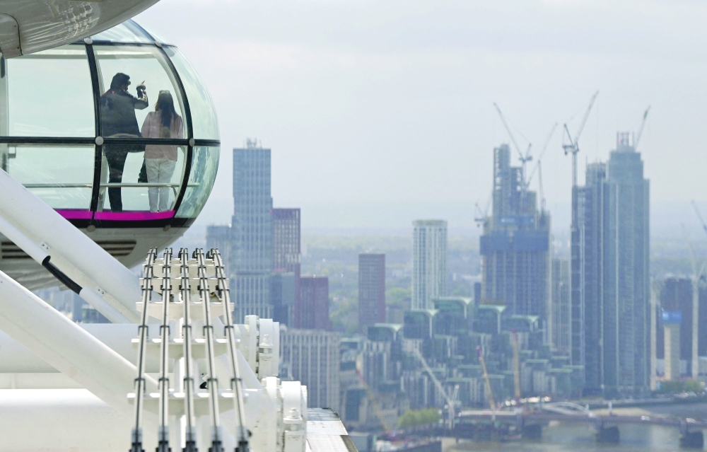 Customers take in the view from a pod on the re-opened London Eye tourist attraction in London as Covid-19 lockdown restrictions ease across the country. - AFP
