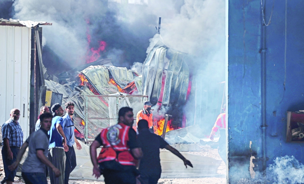 Palestinian firefighters rush to extinguish a huge fire at the Foamco mattress factory east of Jabalia in the northern Gaza Strip, on Monday. - AFP
