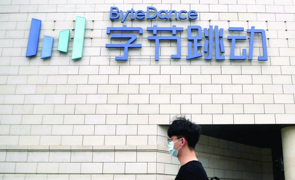 An employee walking outside the headquarters of ByteDance, the owner of video sharing app TikTok, in Beijing. - AFP 
