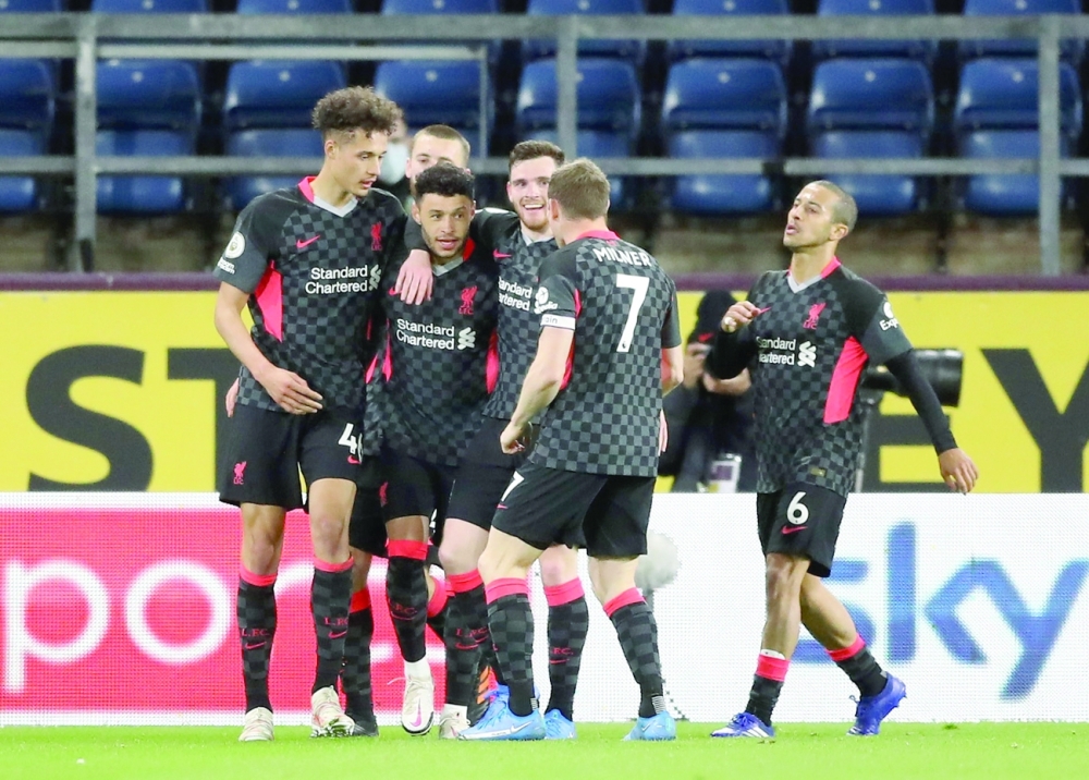 Liverpool's Alex Oxlade-Chamberlain celebrates scoring their third goal with teammates. -- Reuters