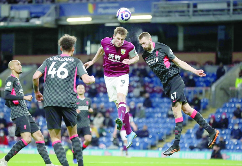 Burnley's Chris Wood in action with Liverpool's Nathaniel Phillips. -- Reuters 