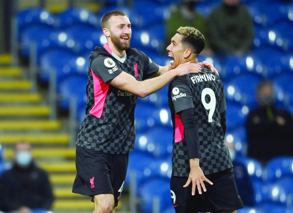 Liverpool's Nathaniel Phillips celebrates scoring their second goal with Roberto Firmino. -- Reuters 