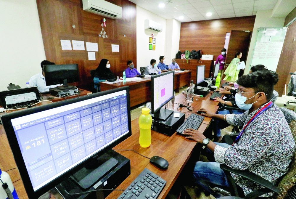 Volunteers work inside a 'war room' set up by Brihanmumbai Municipal Corporation (BMC) to monitor the availability of beds in Covid-19 hospitals across Mumbai. - Reuters 