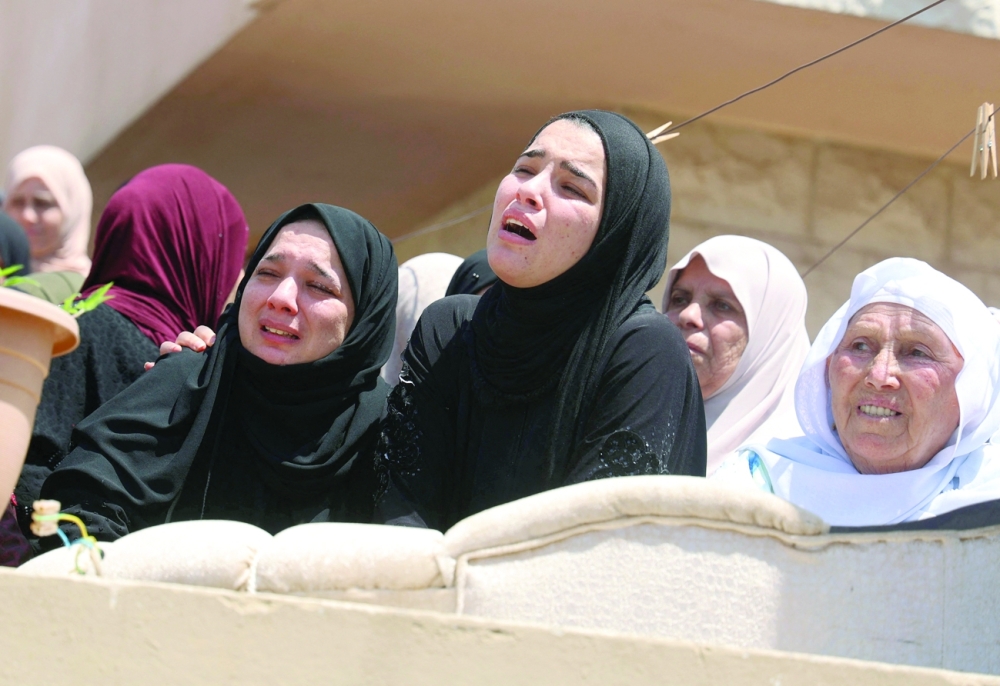 Relatives of 23-year-old Muntaser Jawabreh, who succumbed to his injuries after being wounded mourn at his funeral in the village of Oum Dar east of Jenin in the occupied West Bank. - AFP