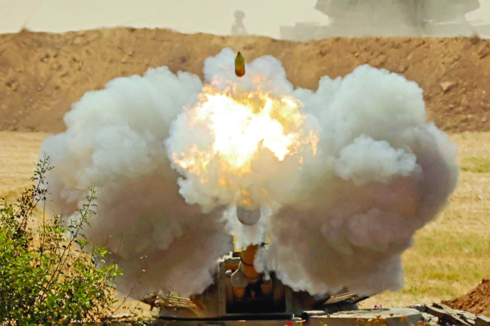 Israeli soldiers fire a 155mm self-propelled howitzer towards the Gaza Strip from their position along the border in the southern Israeli city of Sderot on Thursday. - AFP 