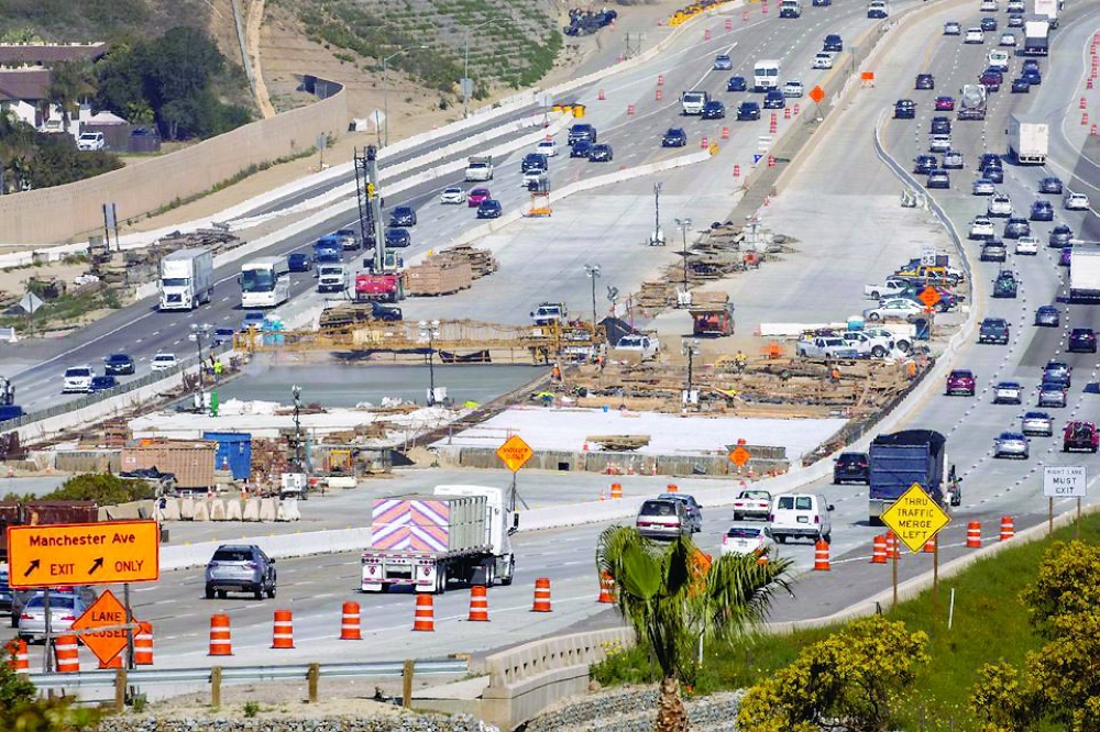 Work crews continue to work on the construction of a freeway overpass in Encinitas, California. — Reuters