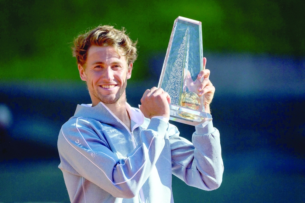 Norway's Casper Ruud raises the trophy after winning the ATP 250 Geneva Open tennis final match against Canada's Denis Shapovalov, in Geneva on May 22, 2021.  / AFP