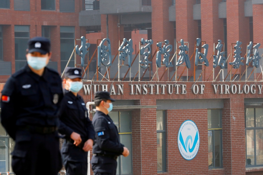 Security personnel keep watch outside the Wuhan Institute of Virology during the visit by the World Health Organization (WHO) team tasked with investigating the origins of the coronavirus disease (COVID-19), in Wuhan, Hubei province, China February 3, 2021. REUTERS/Thomas Peter/File Photo
