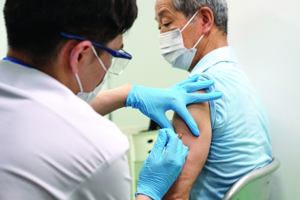 A pensioner receives the Moderna coronavirus disease vaccine at the newly-opened mass vaccination centre in Tokyo. - Reuters