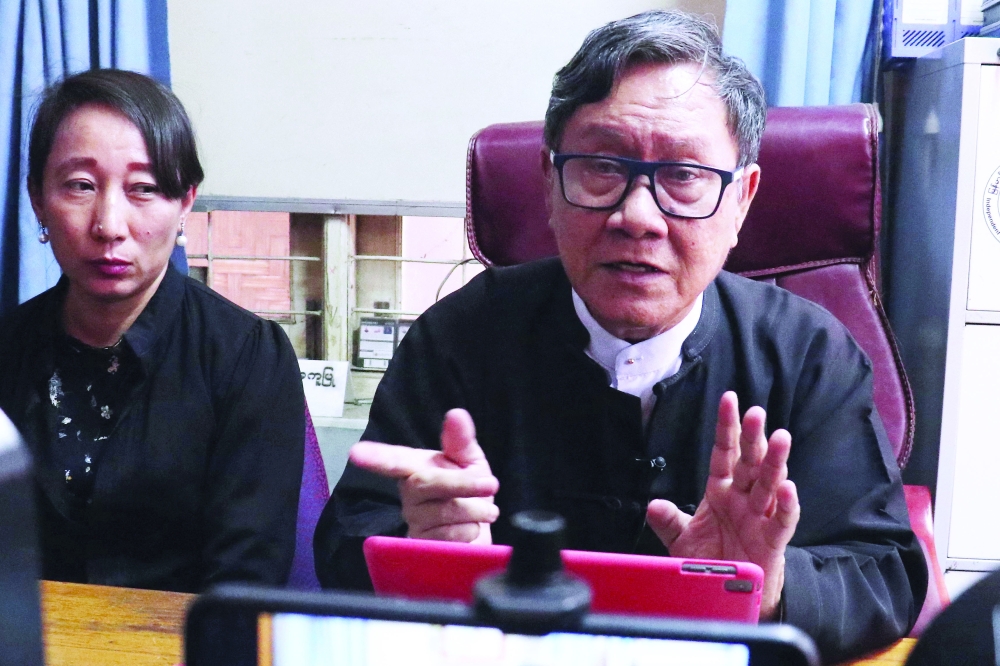 Lawyers Khin Maung Zaw (R) and Min Min Soe, representing detained Myanmar leader Aung San Suu Kyi, address members of the media at Khin Maung Zaw's house in Naypyidaw. - AFP