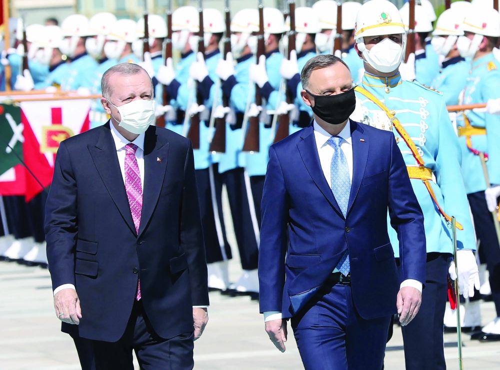 Turkish President Recep Tayyip Erdogan welcomes Poland's President Andrzej Duda ahead of their meeting at the Presidential Complex in Ankara. - AFP 