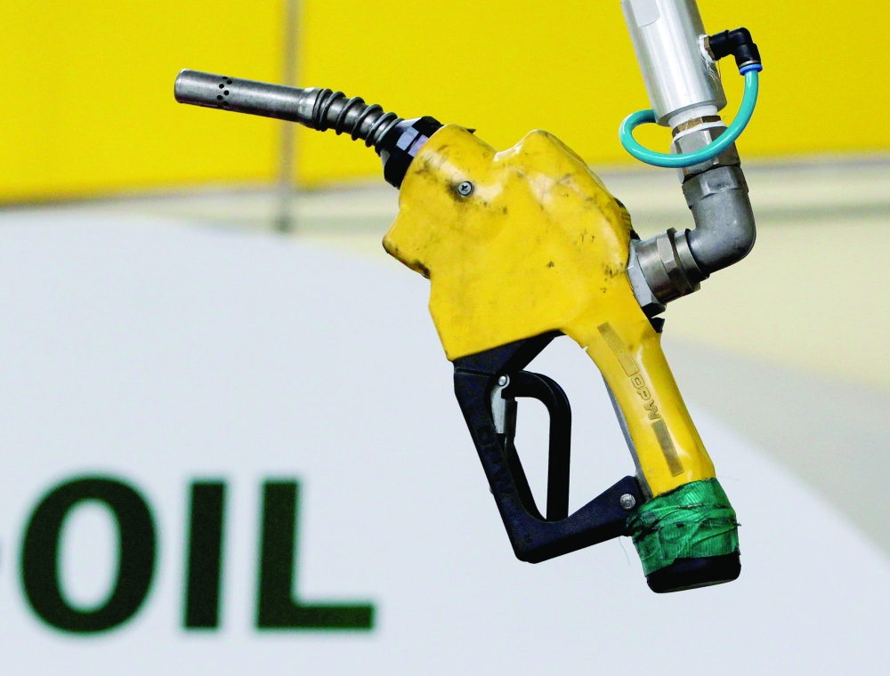 A gas pump is seen hanging from the ceiling at a petrol station in Seoul, South Korea. — Reuters