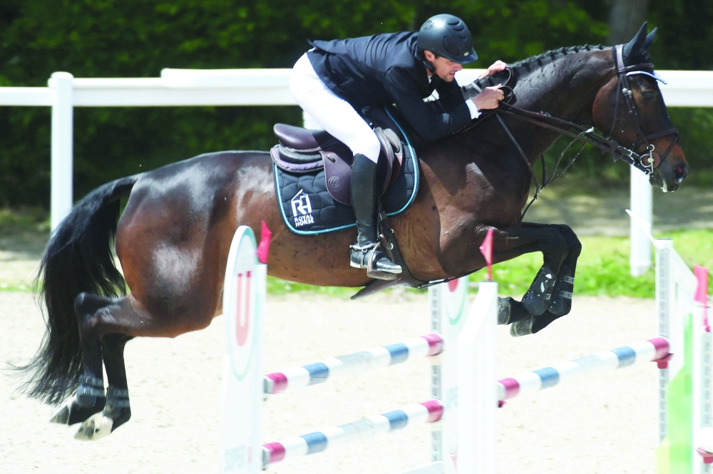France's rider Nicolas Touzaint competes with his horse 'Absolut Gold HDC', during a preparatory event for the Tokyo Olympic Games, near Angers, western France. -- AFP