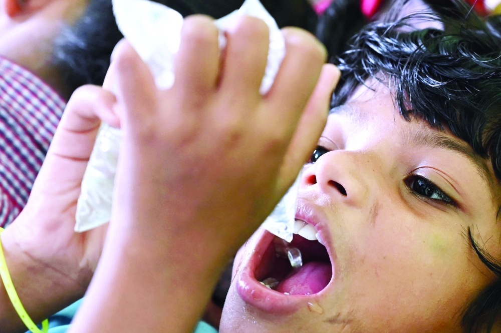 A boy drinks water at a shelter in Digha near Kolkata on Tuesday. — AFP
