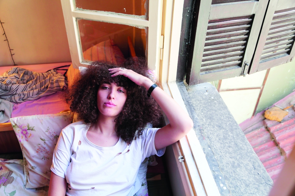 Ghenwa, 20, a trainee flight attendant, poses for a photograph 
in her room in Damascus. — Reuters