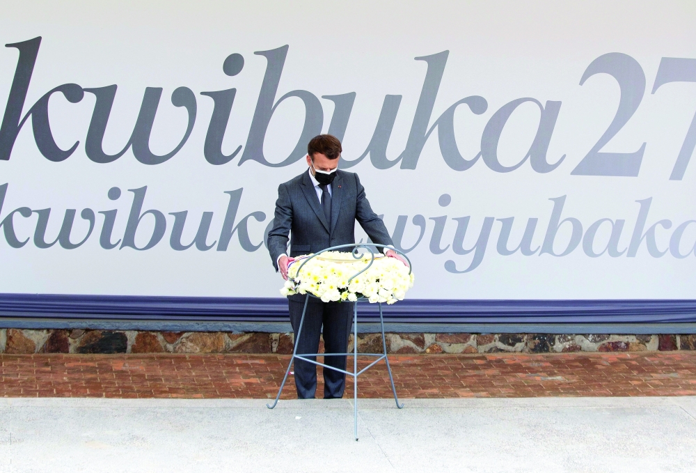 French President Emmanuel Macron lays a wreath on a mass grave containing the remains the victims of the 1994 Rwandan genocide at the Kigali Genocide Memorial Center at Gisozi in Kigali on Thursday. — Reuters
