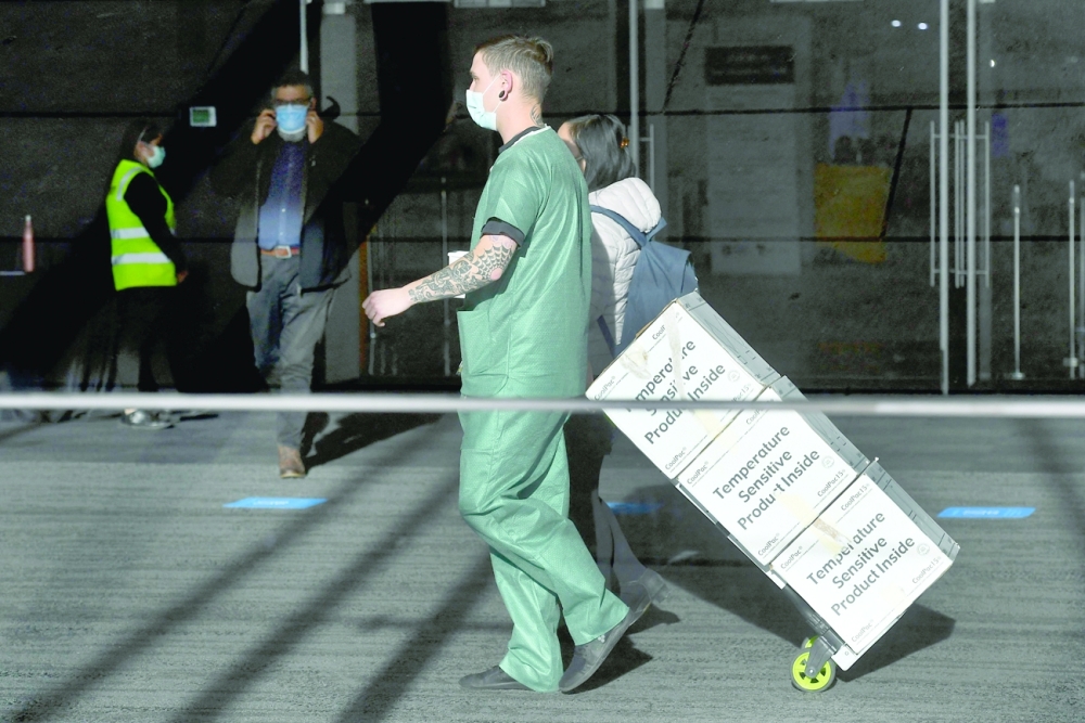 A worker wheels vaccines into a Covid-19 vaccination centre in Melbourne.  AFP 
